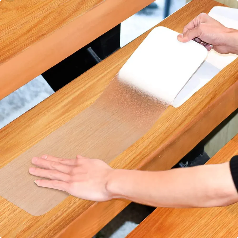 LifeKrafts transparent PEVA anti-skid strip applied to wooden stairs for added traction