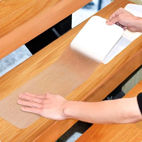 LifeKrafts transparent PEVA anti-skid strip applied to wooden stairs for added traction