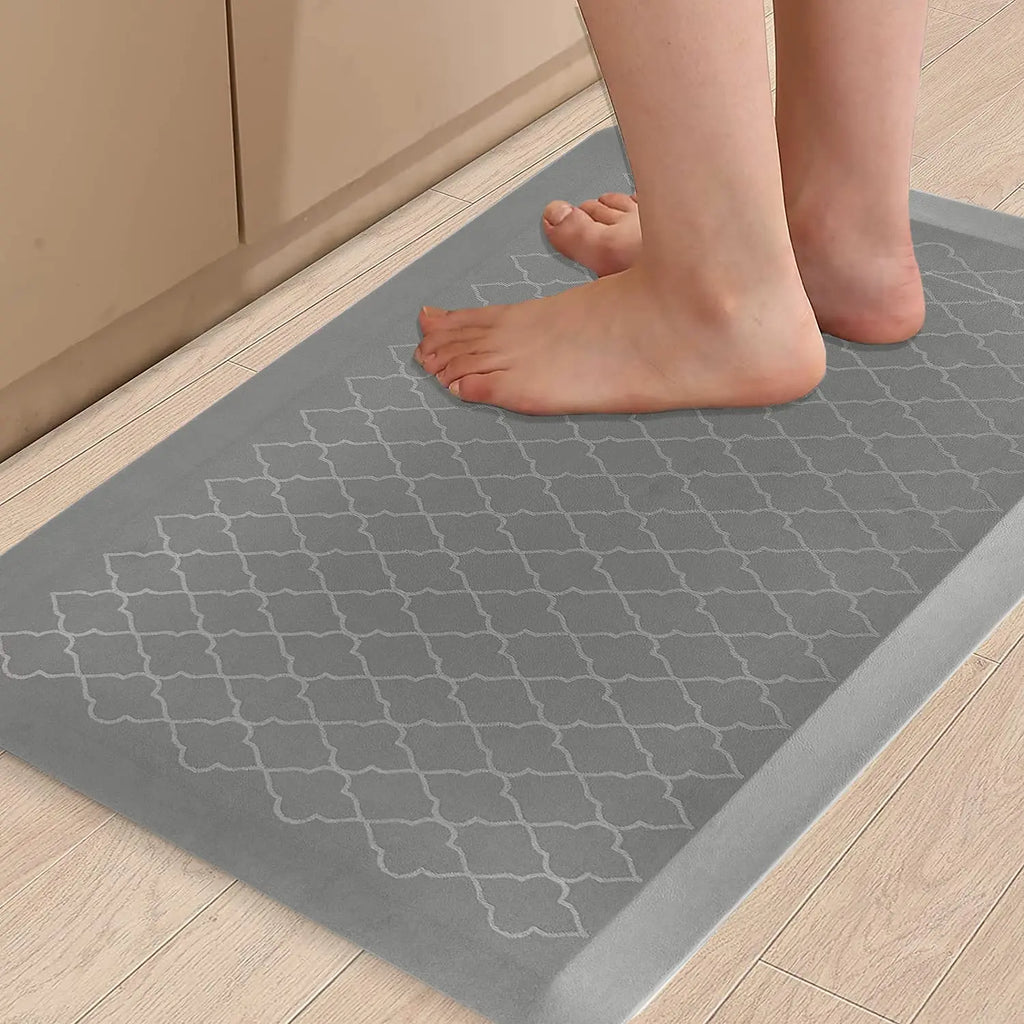 Grey cushioned anti-fatigue floor mat providing comfortable support while standing in the kitchen