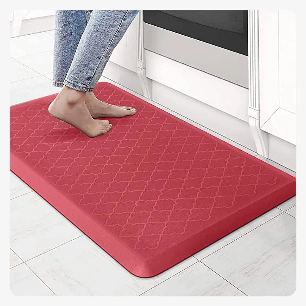 Red cushioned anti-fatigue kitchen mat with patterned surface for standing near kitchen counters