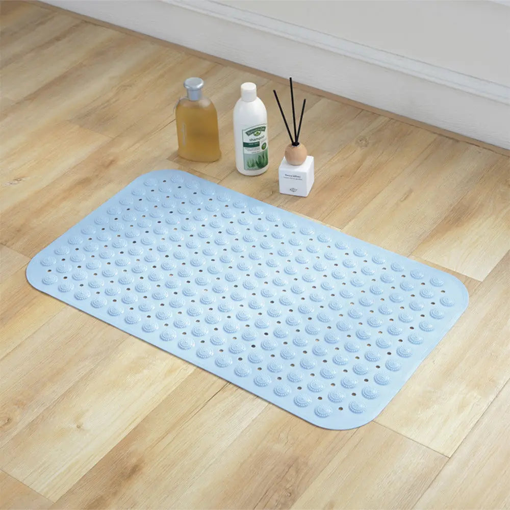 Blue Accu-Pebble non-skid bath mat placed on a bathroom floor for shower area use