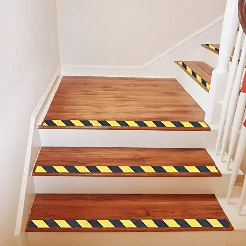 LifeKrafts yellow and black anti-skid tape applied to wooden indoor stair edges