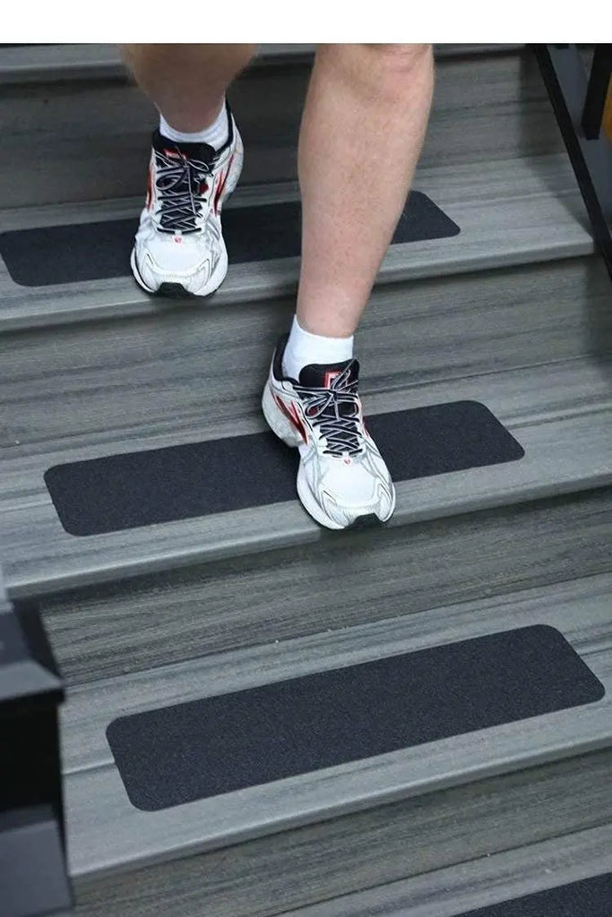 Black anti-slip strips installed on steps for improved traction while walking