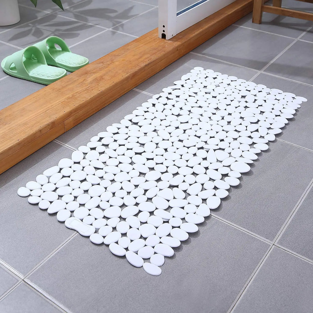 White stone pebble bath mat with textured surface and suction cup floor grip