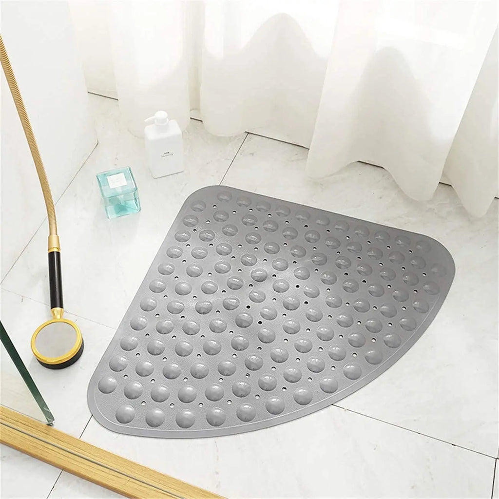 Grey triangle anti-slip shower bath mat with soft pebble surface on bathroom floor