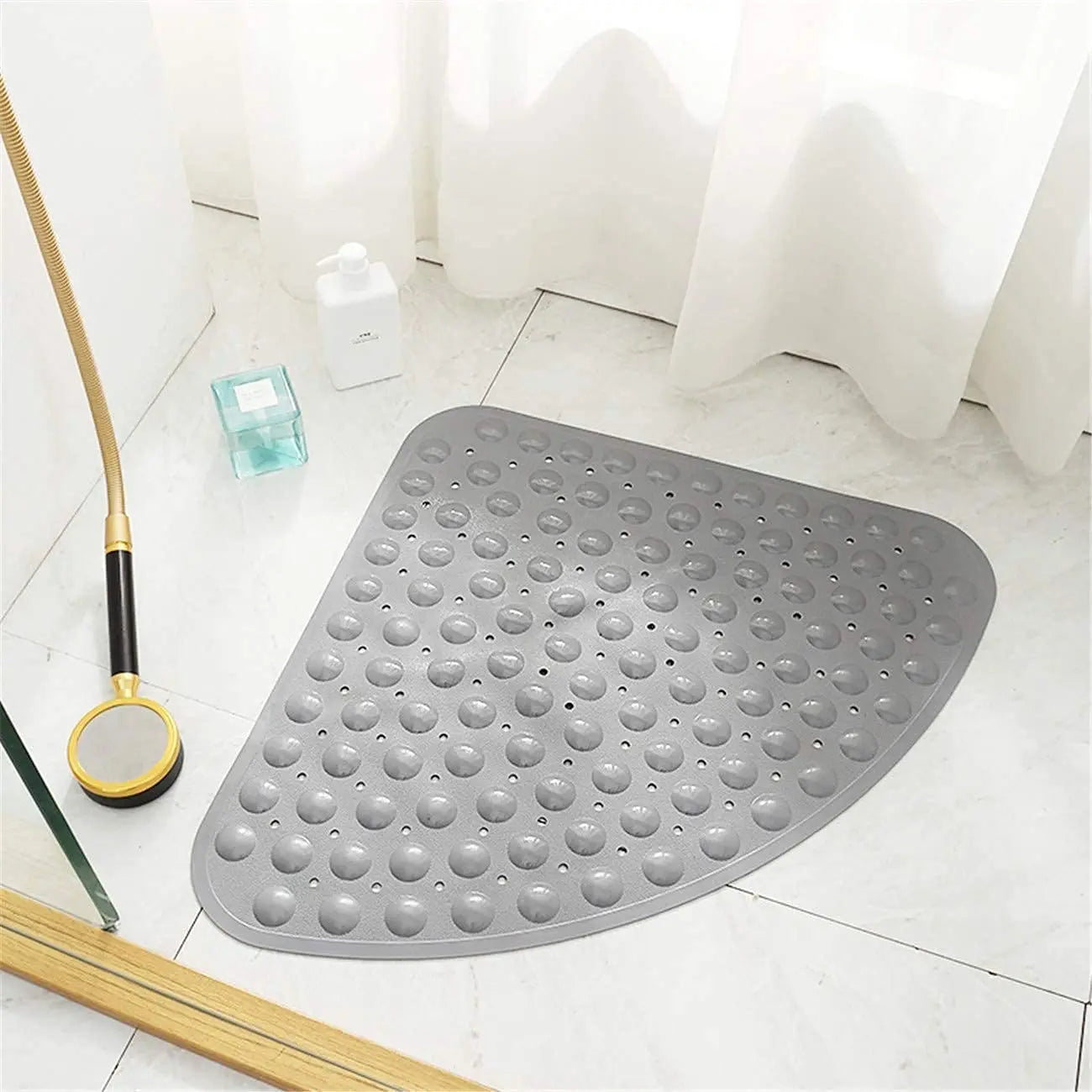 Grey triangle anti-slip shower bath mat with soft pebble surface on bathroom floor