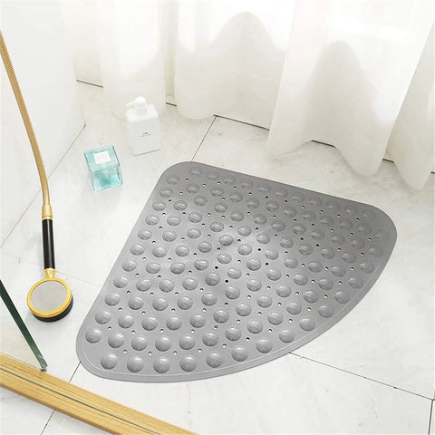 Grey triangle anti-slip shower bath mat with soft pebble surface on bathroom floor