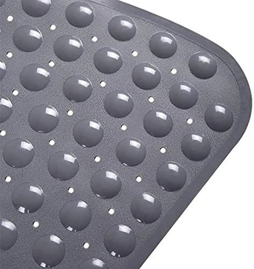 Close-up of grey anti-slip bath mat soft pebble texture with water drainage holes