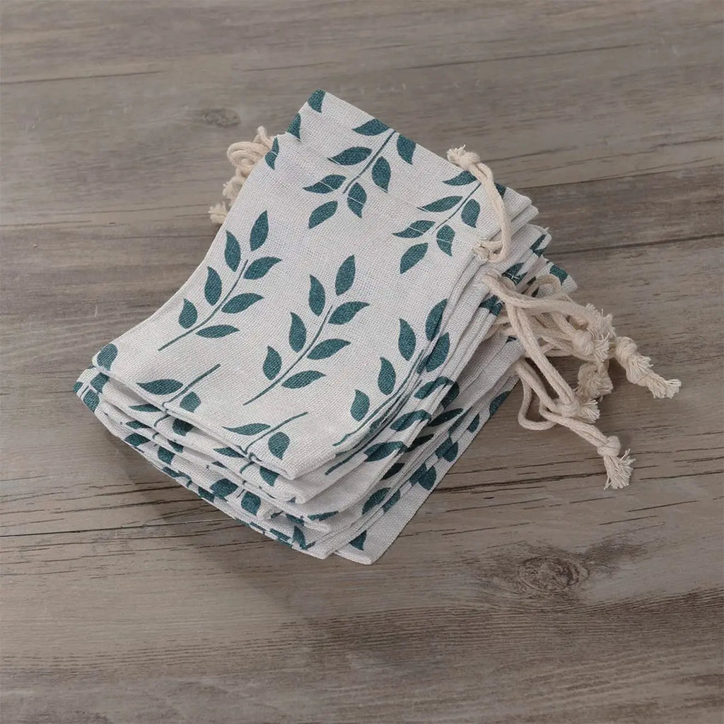 Leaf print jute pouches filled with sweets and return gifts for festive occasions