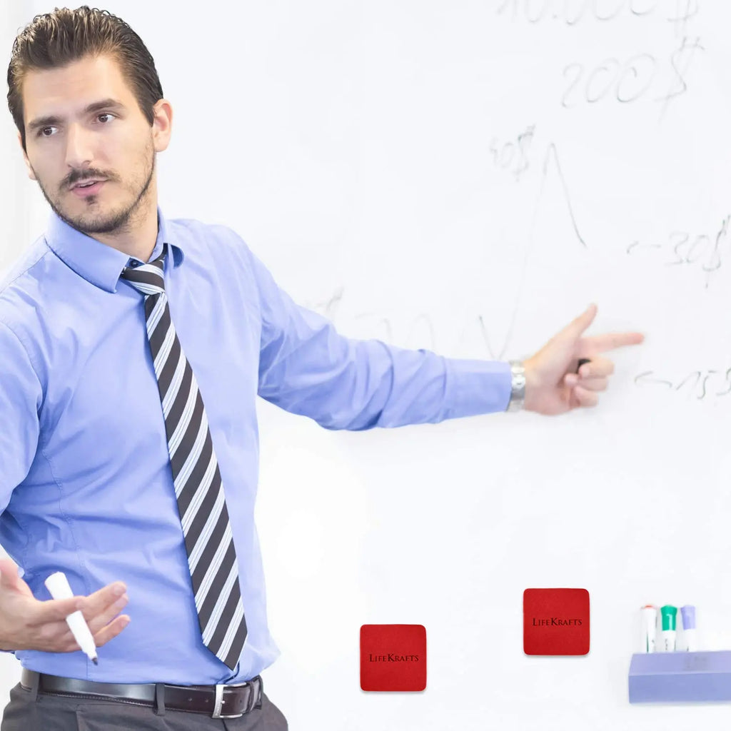 Red magnetic dry erase erasers attached to whiteboard for classroom and office use
