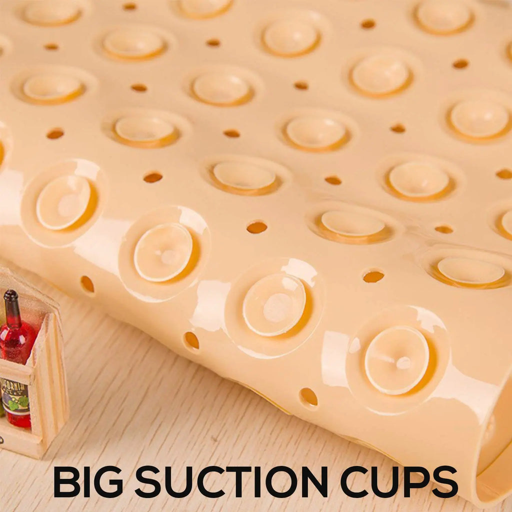 Cream anti-slip bath mat underside showing large suction cups and drainage holes