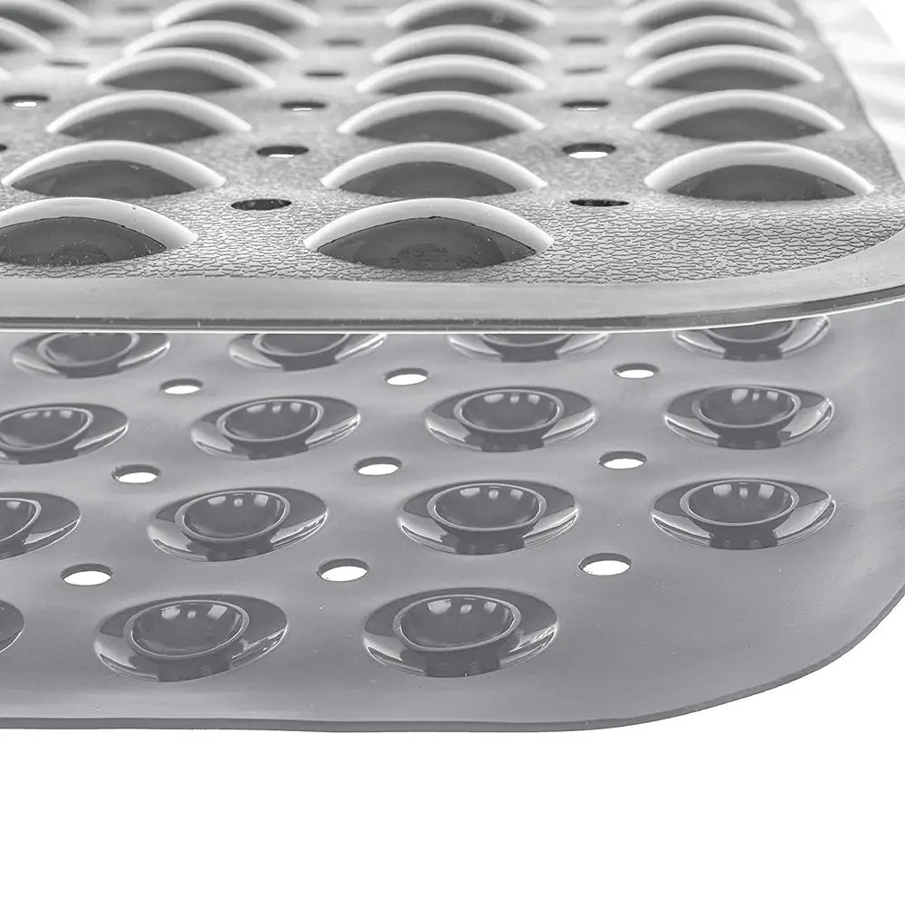 Close-up of grey Soft Pebble bath mat showing raised texture drainage holes and suction cup underside