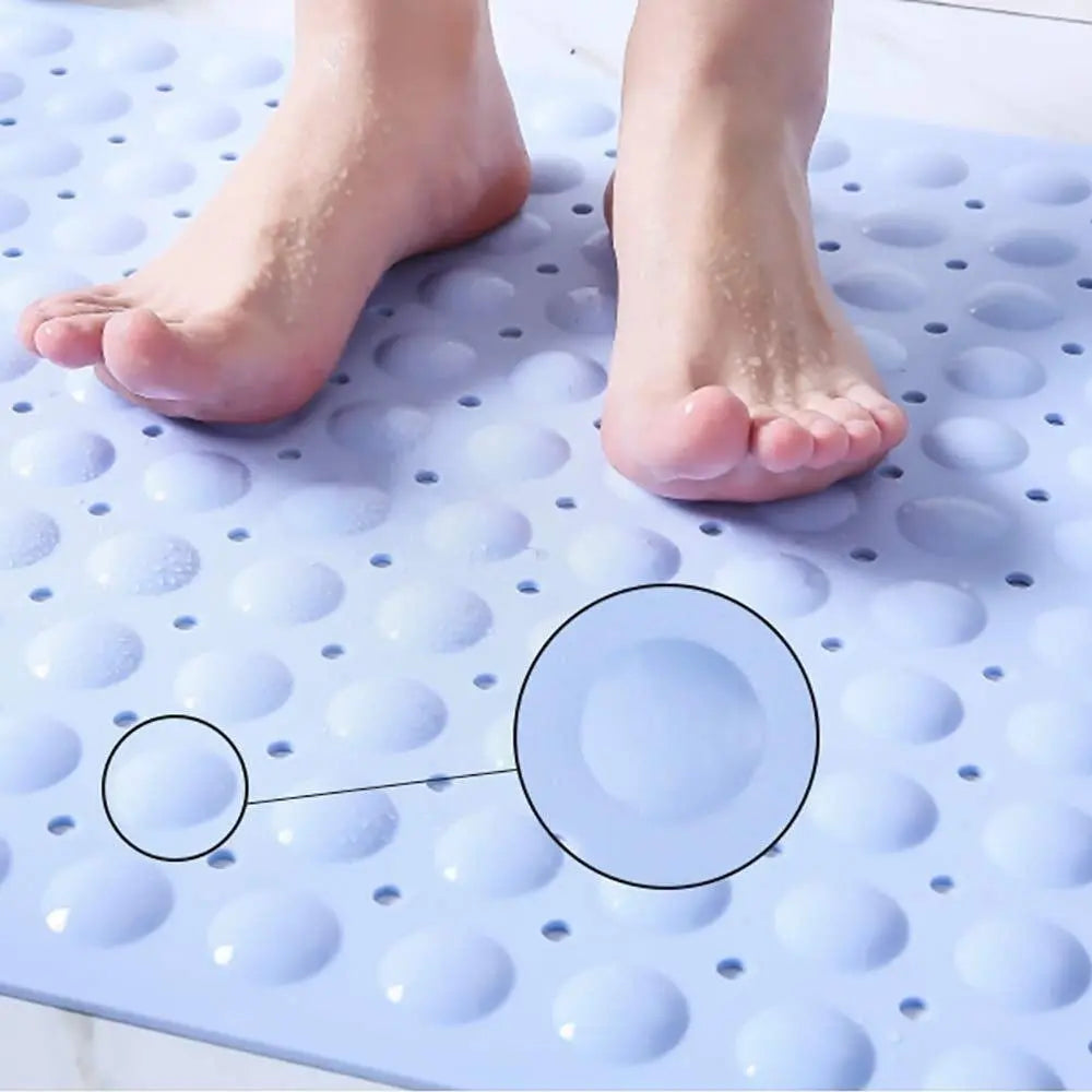 Blue Soft Pebble anti-slip bath mat with raised textured surface and drainage holes underfoot