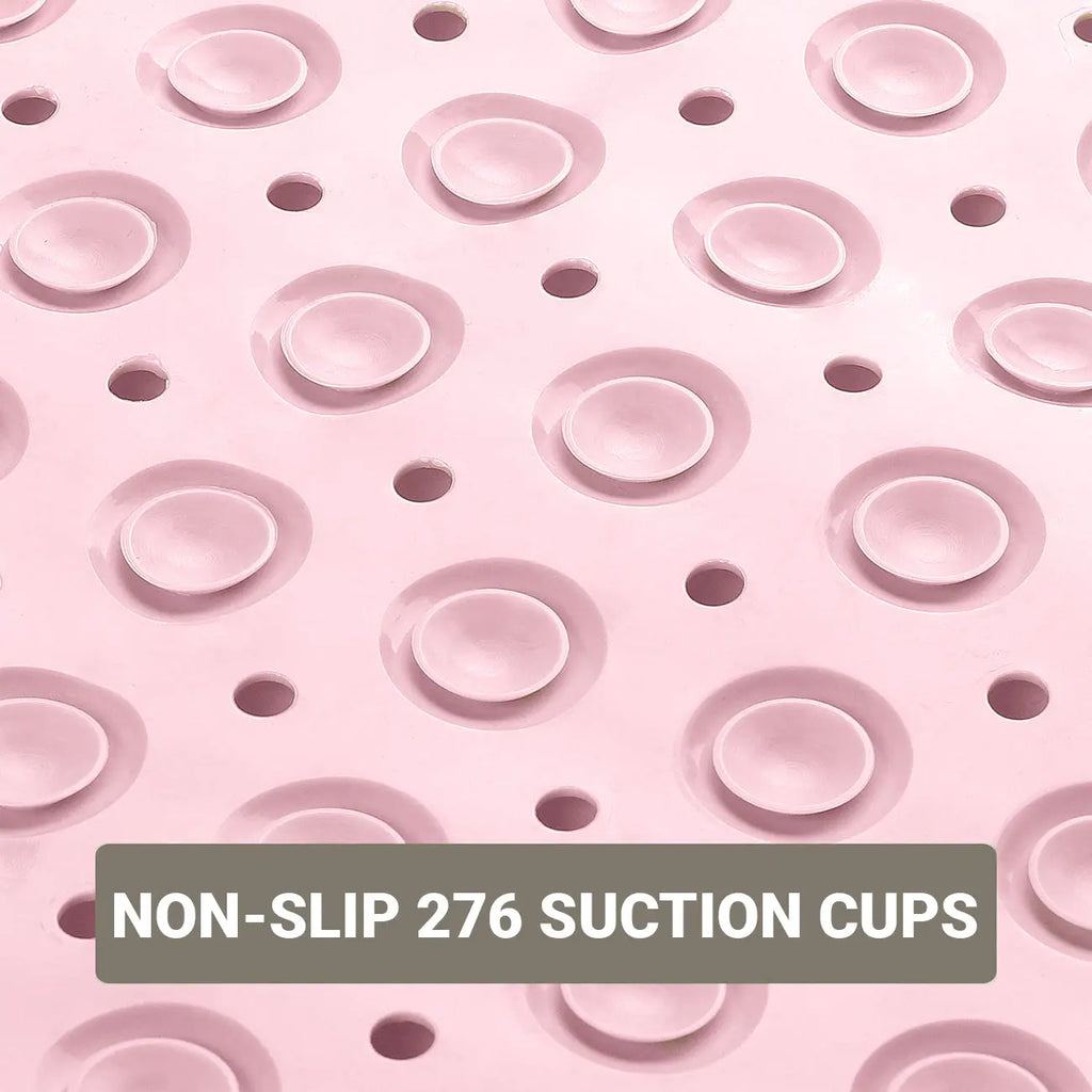Drainage holes on pink soft pebble bath mat for water flow on shower floors