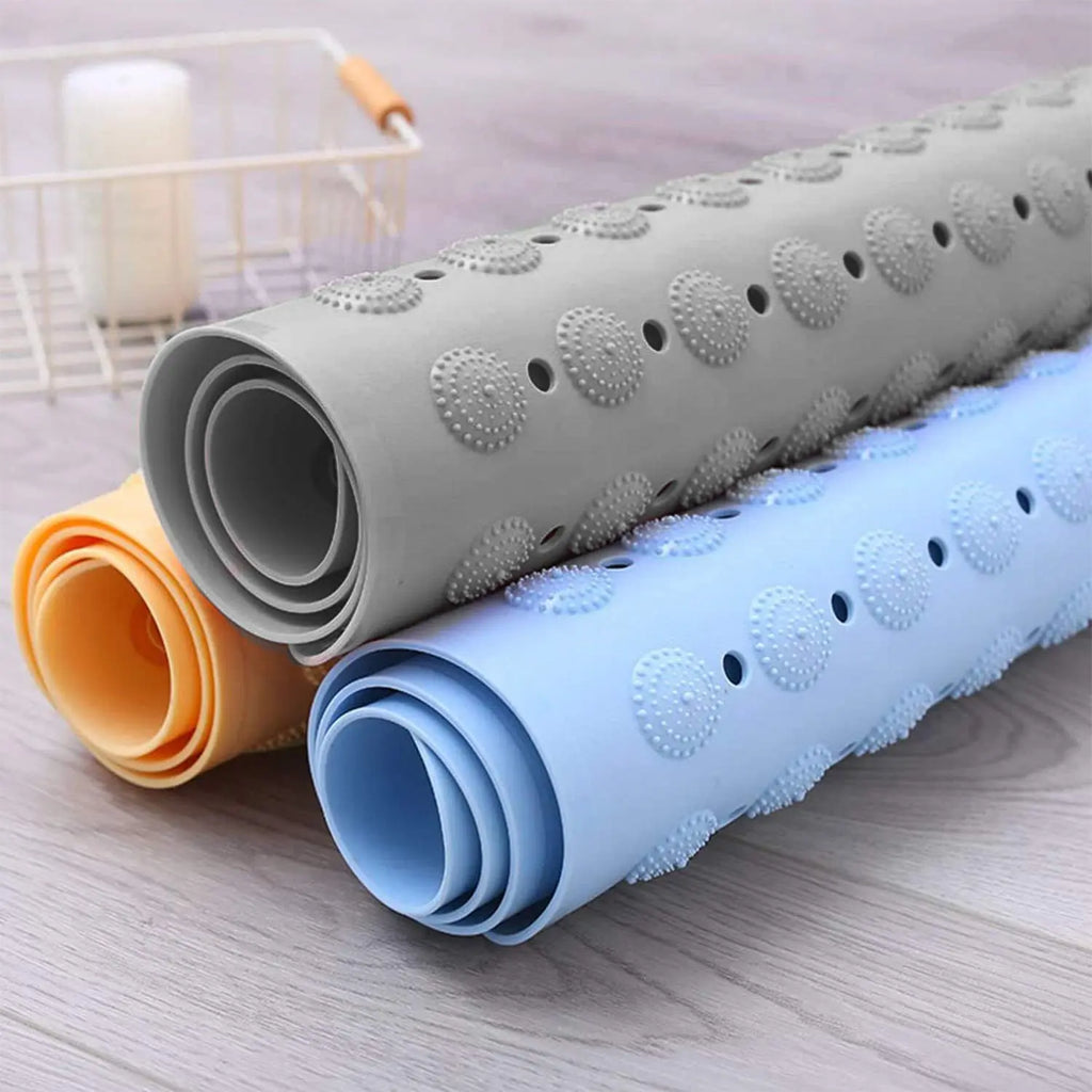 Rolled Accu Pebble anti-slip bath mats showing flexible textured surface and drainage holes