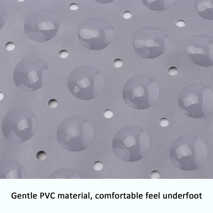Close-up of grey soft pebble bath mat with textured PVC surface and drainage holes