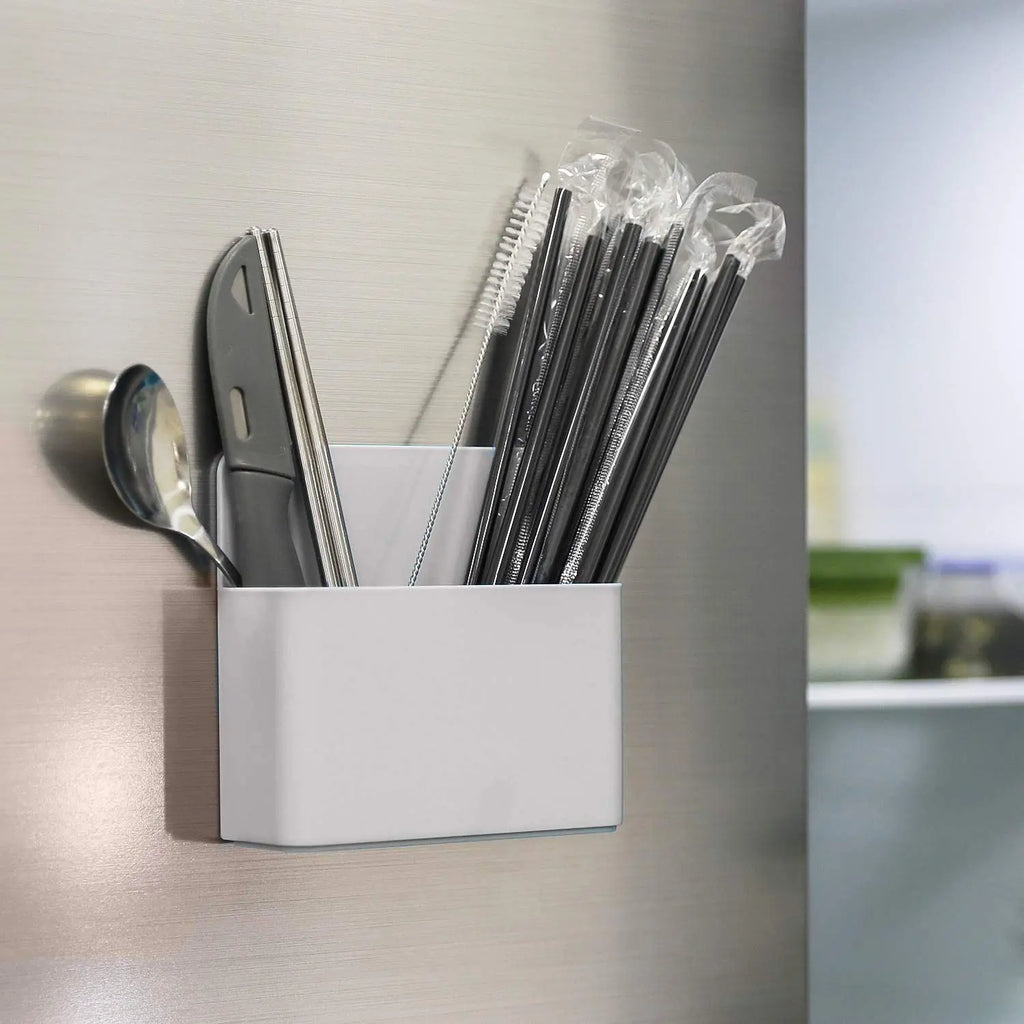 Grey magnetic holder attached to refrigerator for pens and kitchen utensil storage