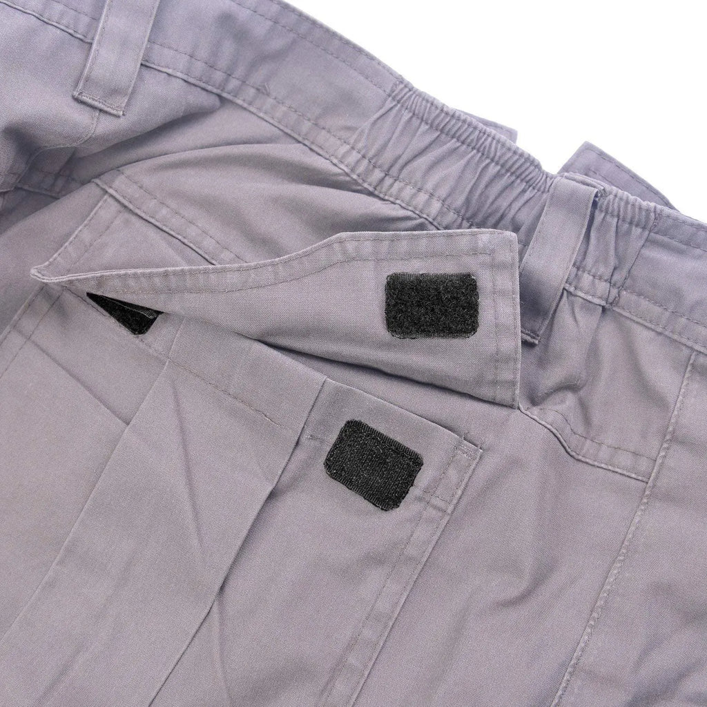 Black sew-on hook and loop fastener attached to clothing for reusable closure
