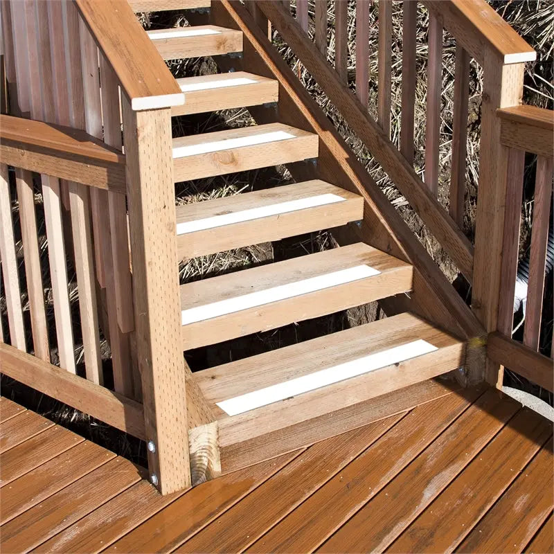 White anti-slip safety tape strips applied to wooden outdoor stair treads