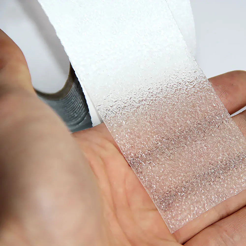 Close-up of white anti-skid tape showing textured abrasive non-slip surface